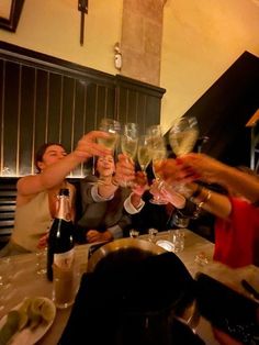 a group of people toasting with wine glasses