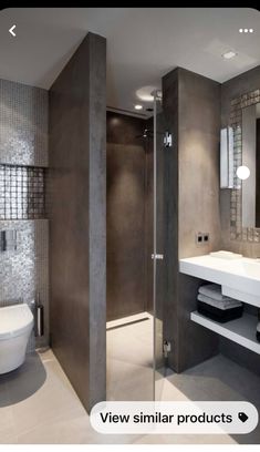 a bathroom with a toilet, sink and shower stall in the middle of it's walls