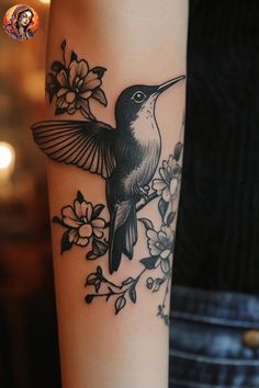 a hummingbird on the arm with flowers around it