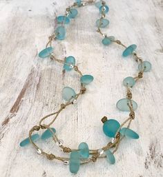 Caribbean aqua blue sea glass and silver beads are hand knotted in this versatile and stylish 22 inch FREESTYLE wrap! Wear it as a necklace, lariat, choker, triple wrap bracelet, double wrap anklet, even as a hair crown or accent braid! Our special infinity loops allow you to tuck the end in anywhere along the cord, or let it dangle! You can even connect them together using the loop and ball to create a stunning stacked and layered look! As with all handmade items, please allow for slight variat Caribbean Jewelry, Blue Sea Glass Necklace, Island Jewelry, Triple Wrap Bracelet, Ocean Necklace, Surfer Necklace, Sea Glass Pendant, Blue Sea Glass, Sea Glass Necklace