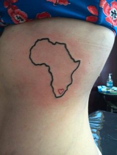 a woman's lower back with a small outline of africa on the side of her stomach