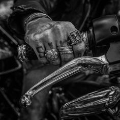 black and white photograph of a person's hand on a motorcycle handlebars