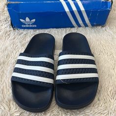 Adidas Adilette J Originals Navy Blue Slides With White Strips Size 4 Nwt Comes With The Box But The Box Is Pretty Beat Up Adidas Blue Open Toe Sandals, Blue Sporty Flip Flops For Vacation, Sporty Blue Flip Flops For Vacation, Navy Slip-on Slides For Summer, Adidas Blue Sandals For Spring, Adidas Blue Slip-on Sandals, Spring Blue Adidas Sandals, Navy Slides With Cushioned Footbed For Summer, Navy Cushioned Slides For Summer