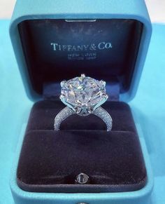 an engagement ring in a blue box with the diamond on it's center stone