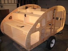 a wooden vehicle with shelves and tools on it