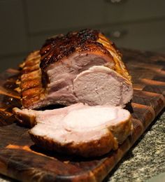 a sliced ham on a cutting board sitting on a counter