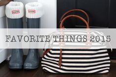 a white and black purse sitting on top of a wooden floor next to rain boots