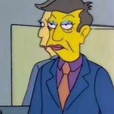 the simpsons is wearing a suit and tie with his eyes wide open as he sits in front of a computer screen