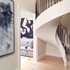 a white spiral staircase in a modern home