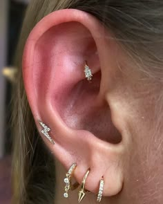 a close up of a person with ear piercings on their left and right sides