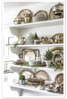 a white shelf filled with lots of plates and silverware on top of each other