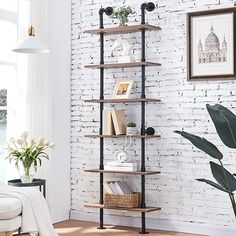 a living room with a white brick wall and shelving unit in the corner,