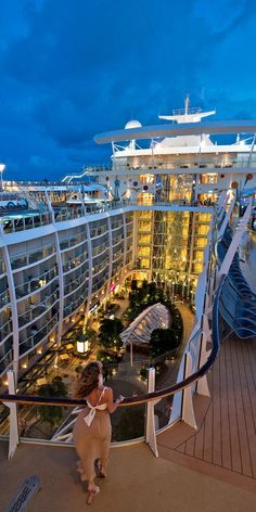 a woman standing on the deck of a cruise ship