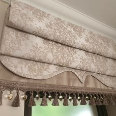 a window curtain with tassels hanging from it