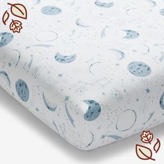 an image of a baby crib sheet with blue stars and moon designs on it