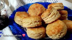 a blue plate topped with biscuits next to a cup of tea