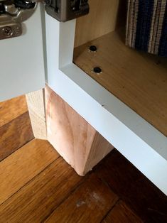 the corner of a kitchen cabinet that has been stripped off and is being used as a shelf