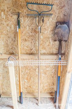 two shovels and some gardening implements in a shed