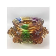 a multicolored glass candle holder sitting on top of a table