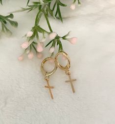 These delicate gold-plated tiny Cross hoop earrings are a mindfulness gift, it's perfect as a Baptism gift or as a girlfriend gift as well.  You will look adorable wearing these dainty earrings. The cute earrings you'll never want to take off. 💗 ITEM DETAILS: The total length of the earrings: 1 inch Charm size: Width 0.7mm -  Height 11mm Materials: 18K Gold plated. Color necklace available: Gold. 💗 GIFT IT Jewelry comes in a cute bag ready to gift! If you wish your item to be a gift, please let me know and I will include a cute little card with a personal message. 💗 CARING FOR YOUR JEWELRY: I recommend that you do not wear your jewelry in the shower, in ocean water, or during sporting activities, and avoid exposure to oils, perfumes, and chemicals that may affect it. Apply all cosmetics Rose Gold Hypoallergenic Dangle Huggie Earrings, Hypoallergenic 14k Gold Filled Rose Gold Huggie Earrings, Small Hoop Gold Cartilage Earrings As Gift, Tarnish Resistant 14k Gold Filled Cartilage Earrings For Gift, Dainty Gold Huggie Earrings For Gift, Rose Gold Plated Huggie Earrings As Gift, Single 14k Gold Filled Huggie Earring For Gift, Hypoallergenic Huggie Cartilage Earrings As Gift, Gift Rose Gold Huggie Earrings, 14k Gold Filled