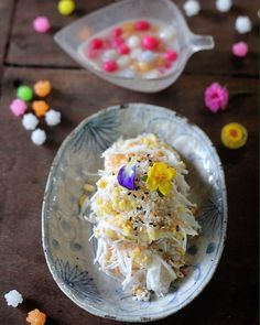 a white plate topped with food next to a plastic container filled with candy candies