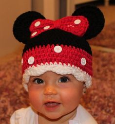 a baby wearing a crocheted minnie mouse hat