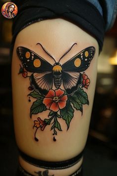 a woman's thigh with a butterfly and flowers tattoo design on the side of her leg