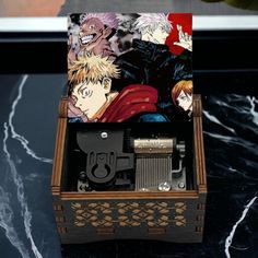 an open wooden box with anime characters on it