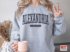 Alexandria Sweatshirt | Soft Cozy Alexandria Virginia Sweatshirt Crewneck Sweater Vintage College University Souvenir Gifts VA USA A sturdy and warm sweatshirt bound to keep you warm in the colder months. A pre-shrunk, classic fit sweater that's made with air-jet spun yarn for a soft feel and reduced pilling. * 50% cotton, 50% polyester * Pre-shrunk * Classic fit * 1x1 athletic rib knit collar with spandex * Air-jet spun yarn with a soft feel and reduced pilling * Double-needle stitched collar, Dorm Gifts, Michigan Sweatshirt, Dorm Gift, Spring Sweatshirt, New York Sweatshirt, Beach Sweatshirt, University Style, Estes Park Colorado, Unique Sweatshirt