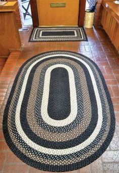 a black and white rug on the ground in front of a door