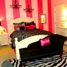 a bedroom decorated in pink, black and white with a zebra print rug on the floor