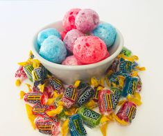 a white bowl filled with candy candies on top of a table