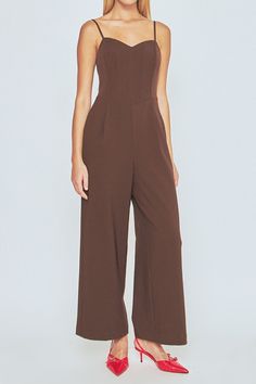 Take your style up a notch with this hot bustier wide leg jumpsuit. With on-trend wide legs and adjustable spaghetti straps, this chic jumpsuit is perfect for any event. And with a backless design, you'll stun everyone in attendance. Dress it up or dress it down this versatile jumpsuit is perfect for any occasion. Add some heels and you're ready to go! Bustier jumpsuit Adjustable spaghetti straps Backless Center zipper Side pockets Wide legs Lined Hand wash cold Do not bleach Do not tumble dry I Elegant Solid Jumpsuits With Spaghetti Straps, Chic Evening Jumpsuit With Spaghetti Straps, Elegant Jumpsuits And Rompers With Spaghetti Straps, Strapless Jumpsuit For Date Night, Elegant Brown Jumpsuits And Rompers For Summer, Elegant Brown Summer Jumpsuits And Rompers, Chic Brown Jumpsuits And Rompers For Party, Chic Brown Jumpsuits And Rompers For Night Out, Bustier Jumpsuit