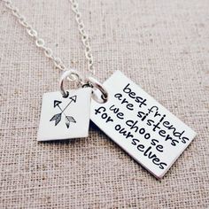 two necklaces that say best friends and one has an arrow on the tag with words