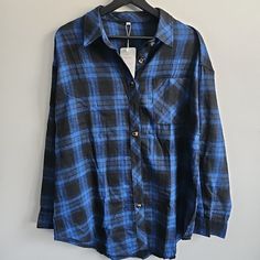 This Blue And Black Plaid Flannel Button-Up Shirt Is Perfect For Women Who Want A Basic Yet Stylish Addition To Their Wardrobe. With A Collared Neckline, Long Sleeves, And A Casual Sleeve Type, This Shirt Is Suitable For Any Occasion. The Shirt Is Made Of Soft Cotton Material With A Flannel Fabric Type That Gives It A Comfortable Feel. The Shirt Is Brand New With Tags And Comes In A Women's Size Large. It Has A Regular Fit, Making It Perfect For Anyone Who Wants A Comfortable And Relaxed Look. T Blue Flannel Shirt For Fall, Blue Buttoned Flannel Shirt For Work, Blue Flannel Shirt With Buttons For Work, Blue Button-up Flannel Shirt For Work, Blue Button-up Flannel Shirt With Snap Buttons, Blue Button-up Flannel Shirt, Blue Flannel, Halloween Inspo, Source Unknown