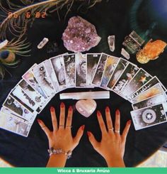 a woman's hands with manicures and cards on top of her table