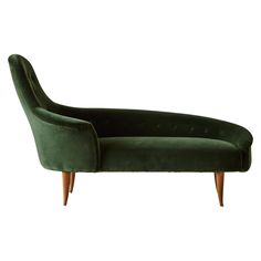 a green velvet chaise lounge chair with wooden legs and feet on an isolated white background