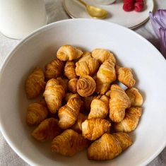 croissants in a white bowl on a table