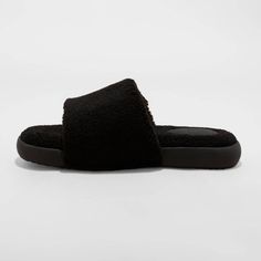 Keep your feet in cozy comfort at home and beyond with these Rodney Adjustable Slide Slippers from Goodfellow & Co™. These slide slippers are lined with faux fur for a soft feel and coziness, while the adjustable hook-and-loop top band provides a snug fit. The slip-on design allows for easy on/off, and they are suitable for both indoor and outdoor wear. Goodfellow & Co™: Where style & fit are always in good company. Comfortable Flat Faux Fur Slippers, Comfortable Faux Fur Flat Slippers, Comfortable Faux Fur Slippers With Cushioned Footbed, Comfy Faux Fur Slippers Super Soft, Comfy Super Soft Faux Fur Slippers, Faux Fur Lined Comfy Slippers, Comfortable Plush Lined Slippers For Loungewear, Cozy Faux Fur Slippers With Cushioned Footbed, Cozy Synthetic Slippers With Textured Footbed