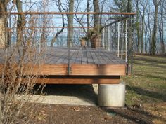 a wooden deck in front of some trees