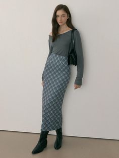 The MOR Check Long Skirt in Mild Gray is a sophisticated maxi-length design featuring a high-waist H-line silhouette with a double back slit for enhanced movement and leg-lengthening effect. The skirt is crafted from a feminine check-patterned polyester fabric that's perfect for transitional fall weather, complete with a lined interior and back zipper closure. Available in sizes S through L with detailed measurements provided, this versatile piece requires dry cleaning to maintain its polished a High Waisted Maxi Skirt, Fall Weather, Long Skirt, Maxi Skirt, Polyester Fabric, Midi Skirt, High Waisted, Outfit Inspo, Grey