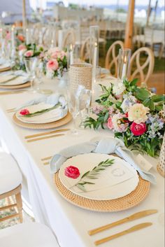 the table is set with plates and place settings