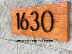 a close up of a wooden sign on a wall with the number 1380 in it