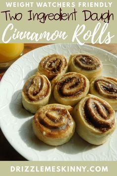 cinnamon rolls on a white plate with the words weight watchers friendly two ingredient dough cinnamon rolls