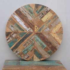 a wooden clock sitting on top of a shelf