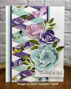 a close up of a card with flowers on the front and bottom, along with text that reads thinking of you