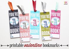 four bookmarks with ribbons hanging from them on a white background and the words you're