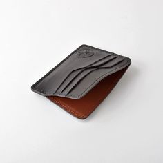 This wallet is made using top grain cowhide, featuring contrasted smooth and textured leathers for each card slot. The wallet features 4 card slots on either side and a interior pouch for bills. Made in CanadaGenuine Cowhide Leather Black Leather Trifold Card Holder, Leather Business Card Holder With Interior Slots, Leather Wallets With Card Slots For Business, Modern Leather Card Holder With Interior Slots, Modern Leather Card Holder With Coin Pocket, Leather Bifold Card Holder For Business, Smooth Grain Bifold Card Holder For Business, Business Leather Card Holder With Coin Pocket, Leather Trifold Wallet With Card Slots For Business