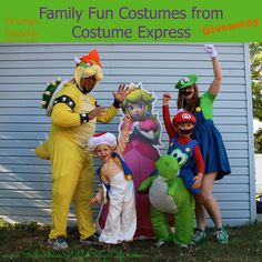 some people in costumes are posing for a picture with one child and the other adult