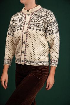 This vintage Dale of Norway cardigan is crafted from pure wool and showcases traditional Norwegian knit patterns with snowflakes and geometric designs. Dale has been renowned for its high-quality knitwear since 1879, and wool's natural insulation makes this piece perfect for colder months. Complete with classic pewter buttons, this cardigan blends style with function. It's in excellent vintage condition. Size about a XS (EU 34, IT 38, UK 6). I am 175 cm (5'9") tall, usually wearing a size M. As Retro Wool Cardigan With Fair Isle Pattern, Vintage Winter Knitted Patterns, Vintage Knitted Patterns For Winter, Vintage Wool Cardigan With Fair Isle Pattern, Vintage Winter Jacquard Knit Cardigan, Vintage Fair Isle Patterned Sweater, Nordic Jacquard Knit Winter Cardigan, Nordic Jacquard Knit Cardigan For Winter, Cream Nordic Sweater With Fair Isle Pattern